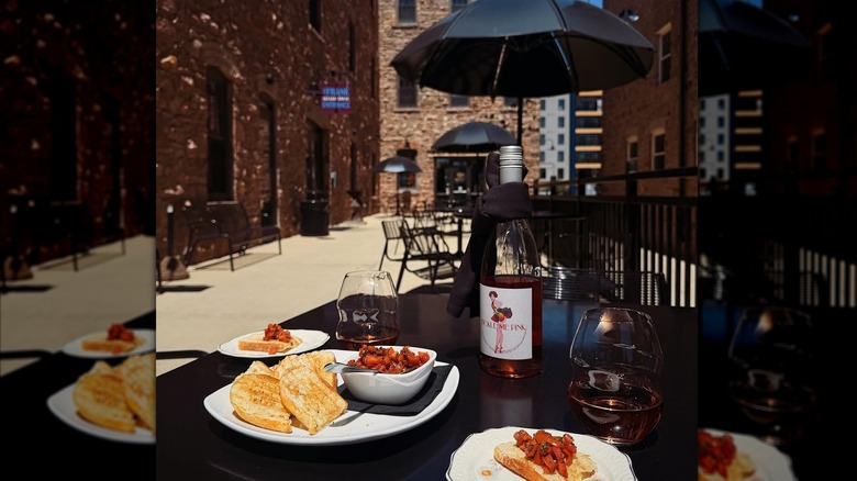 Table with food and rosé wine on the outdoor patio at R Wine Bar & Kitchen