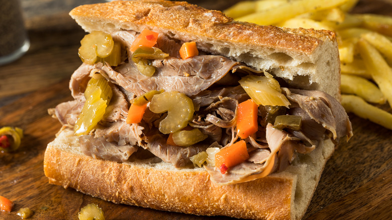 An Italian beef sandwich on a wood table.