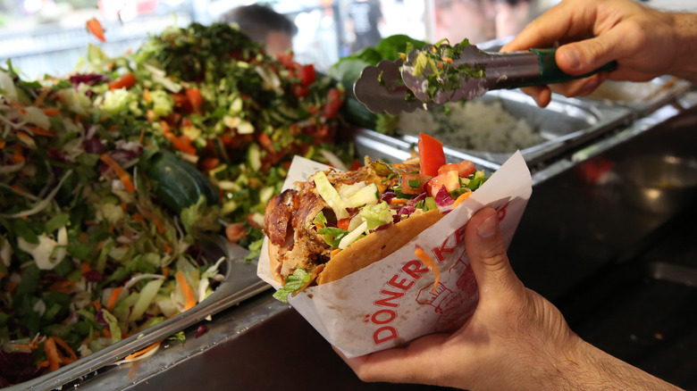 kebab shop worker preparing a kebab