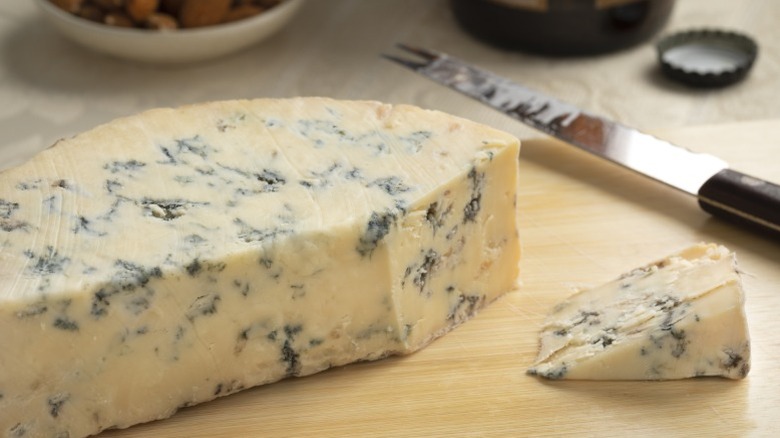 A slice from a wedge of Stilton cheese.