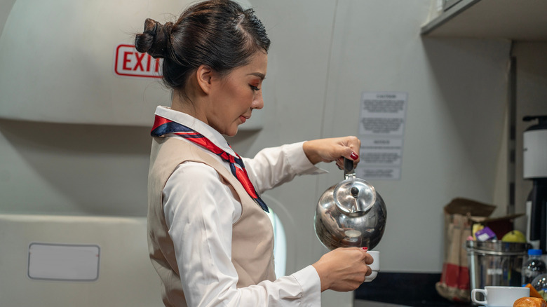 flight attendant pouring coffee