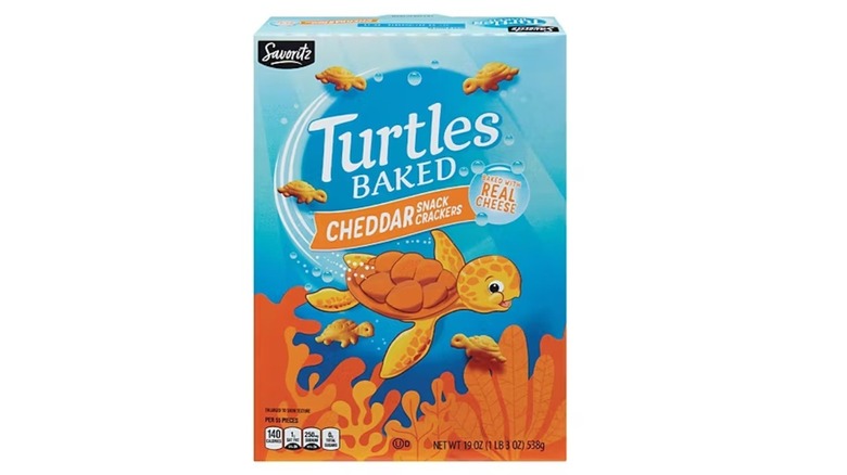 A box of Aldi's Savoritz Turtles Baked Snack Crackers Extra Cheddar on floor tiles