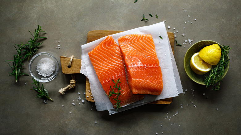 Raw salmon fillets on a wooden board