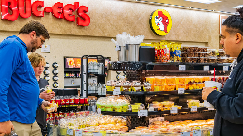 People surrounding the prepared foods section in a Buc-ee's store
