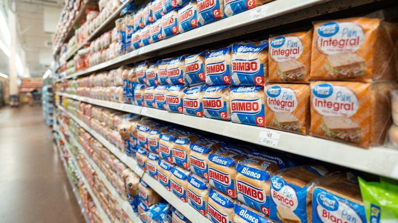 Loaves of Bimbo and Great Value bread on grocery store shelf