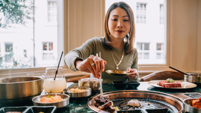 Woman eating barbecue in a beautiful home