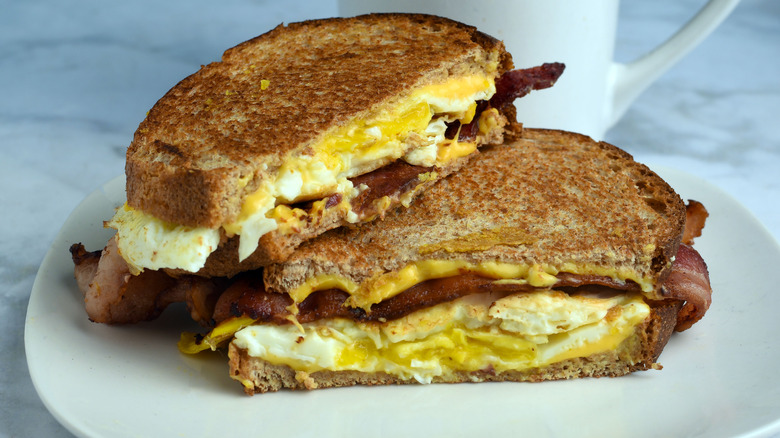 A breakfast melt sandwich with bacon, eggs, and cheese