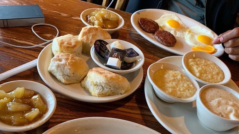 Assorted food items from Cracker Barrel including, biscuits, eggs, sausage, grits, and cinnamon apples