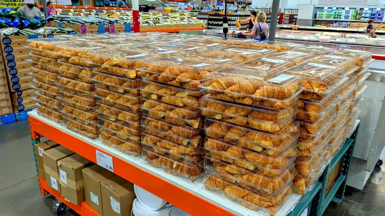 Stacks of Costco bakery fresh croissants in boxes on display