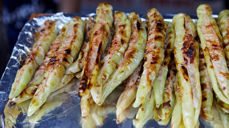 A tray of grilled banana peppers stuffed with pork