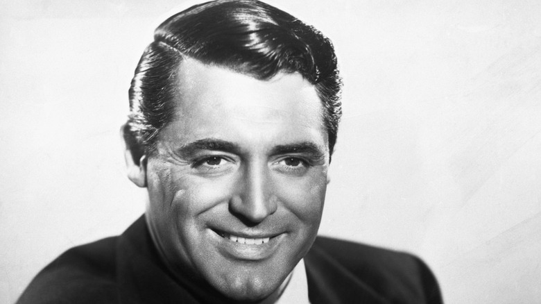 Cary Grant smiling in black and white photo
