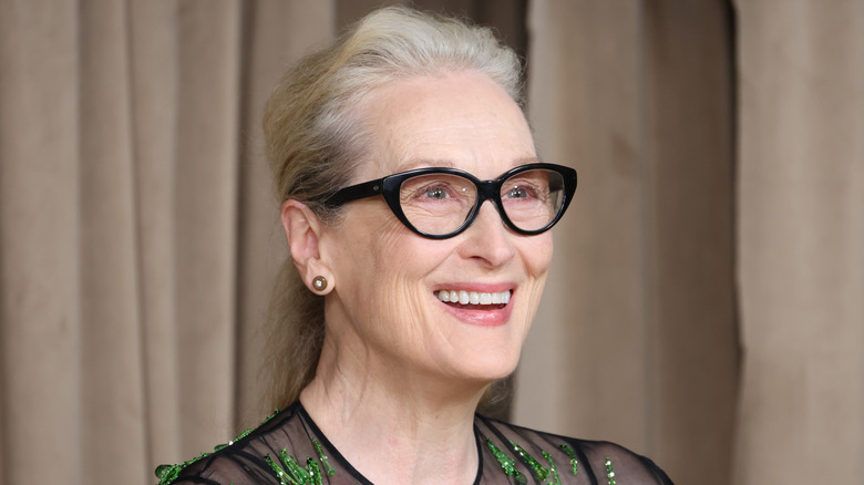 Meryl Streep wearing black glasses and smiling