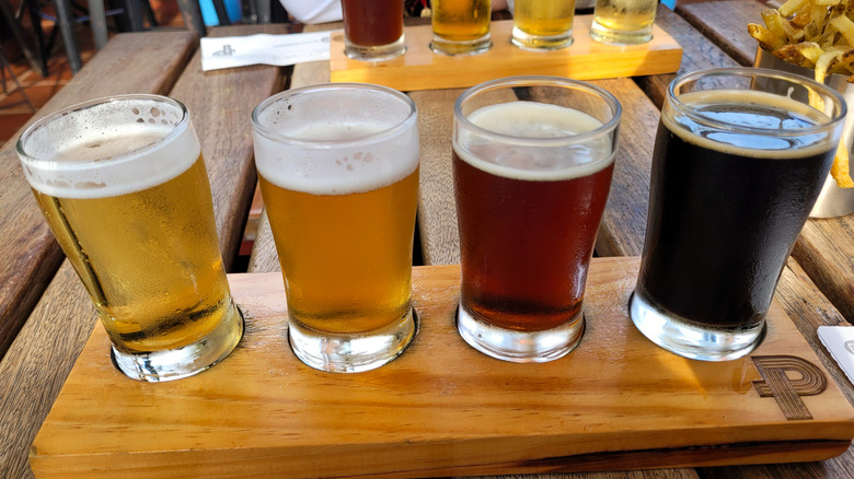 Two flights of four beers apiece on a wooden table
