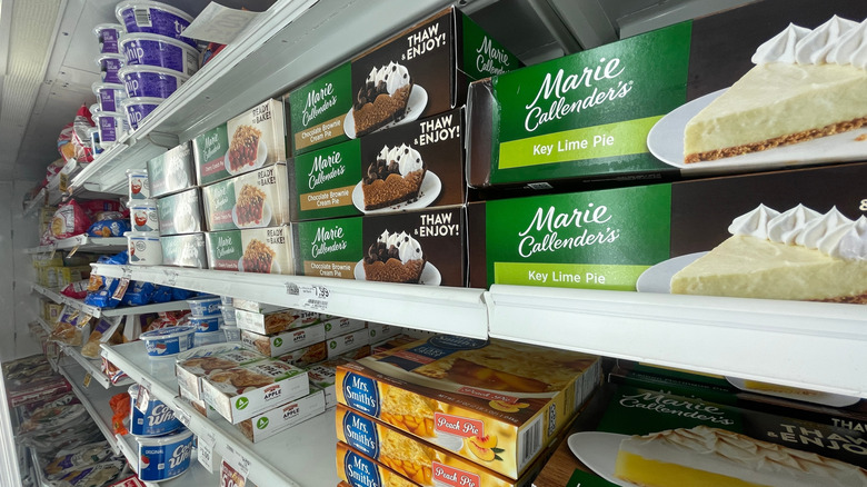 The frozen pie section of a grocery store.