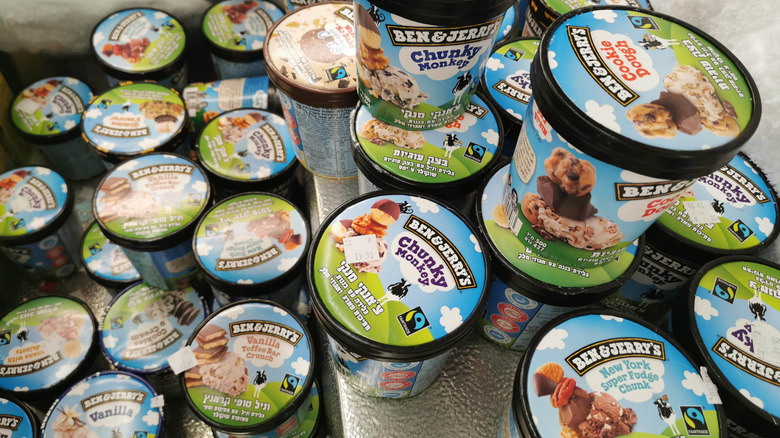 Assorted pints of Ben & Jerry's ice cream stacked in a freezer