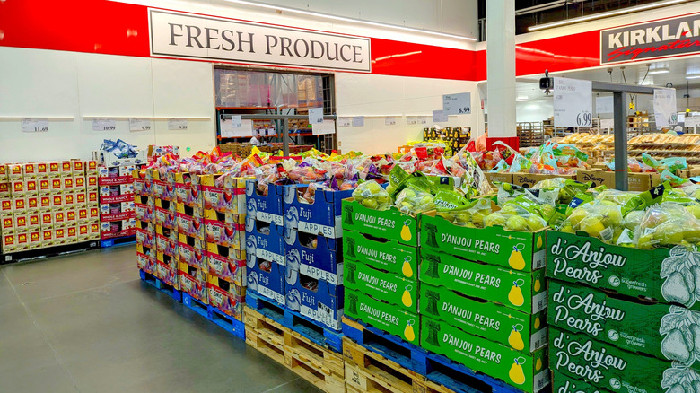 Costco produce area with crates of pears and apples