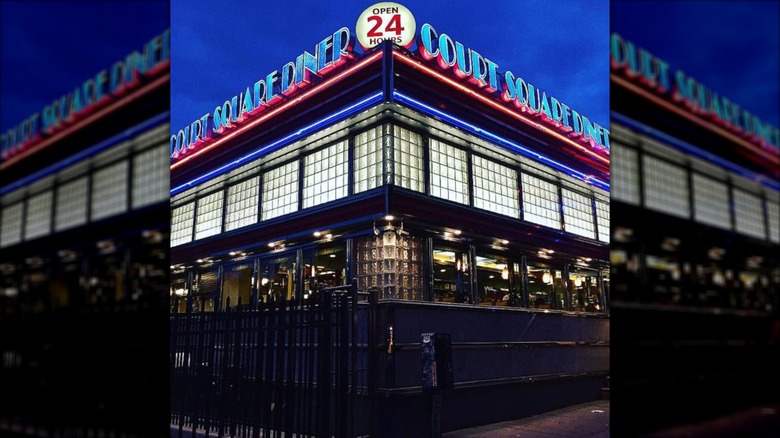 Court Square Diner exterior all lit up in neon at night