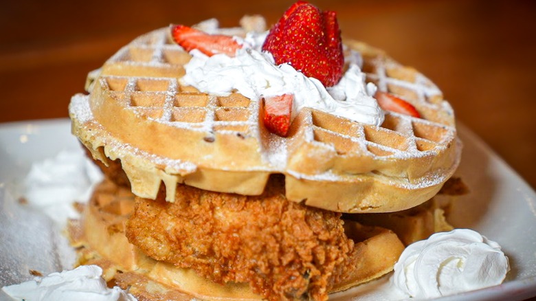 Marietta Diner plate of Golden waffles, crispy fried chicken, whipped cream, fresh strawberries