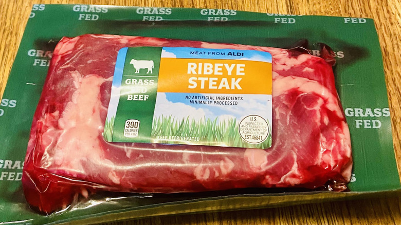 Aldi Grass Fed Ribeye Steak package on wooden table