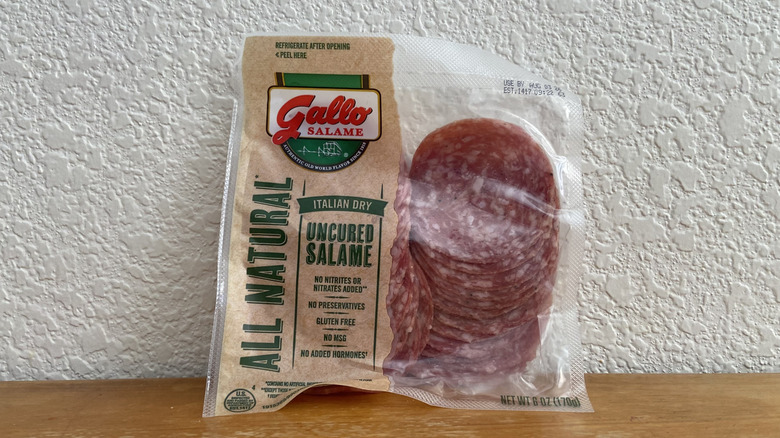 Package of Gallo uncured salami propped up on a wooden table