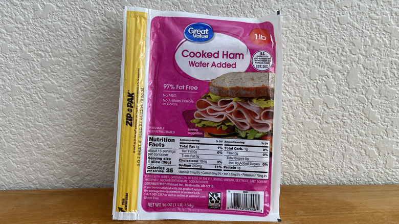 Package of Great Value ham propped up on a wooden table