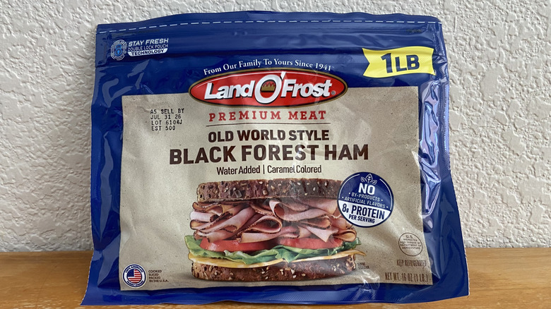 Package of Land O' Frost Black Forest ham propped up on a wooden table