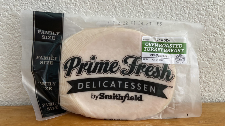 Package of Prime Fresh Delicatessen turkey propped up on a wooden table