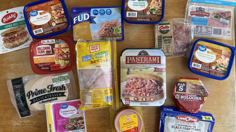 Top-down view of all Walmart deli meats on a wooden table