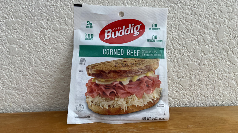 Package of Buddig corned beef propped up on a wooden table
