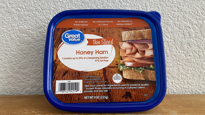 Package of Great Value honey ham propped up on a wooden table