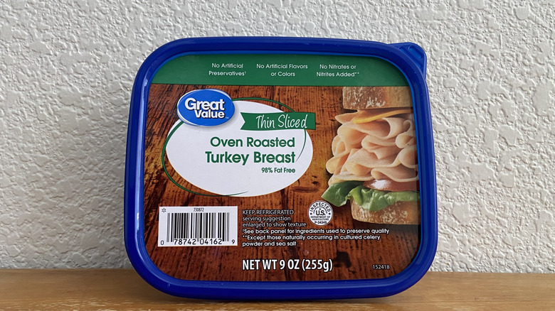 Package of Great Value turkey breast propped up on a wooden table