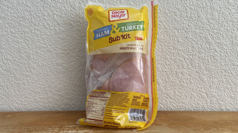 Oscar Mayer ham and turkey sub kit propped up on a wooden table