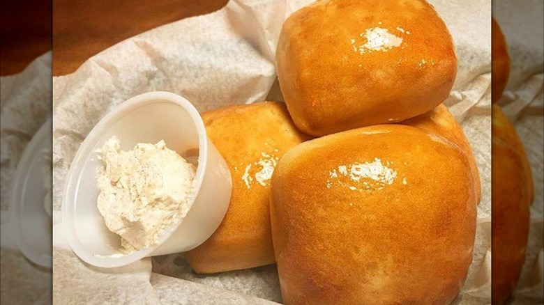 Texas Roadhouse rolls with butter in basket