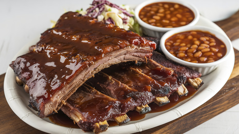 A plate of ribs covered in sauce