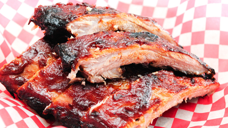 A stack of pork ribs covered in sauce