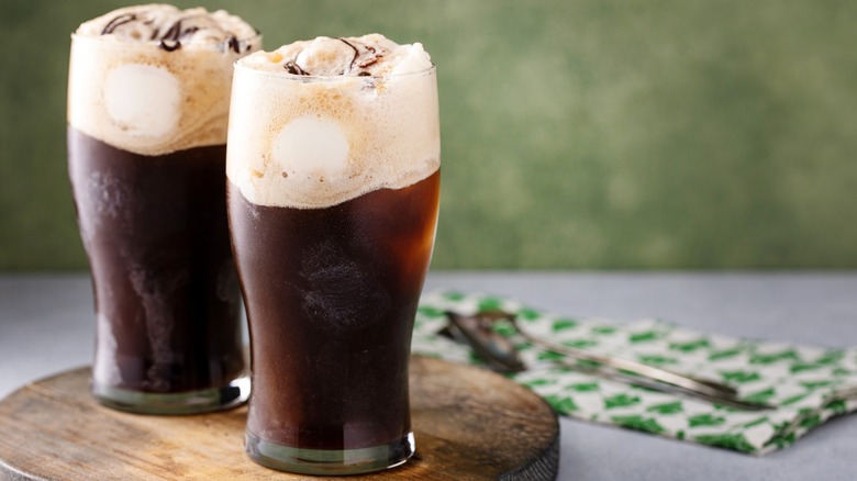 Two glasses containing dark stout beer ice cream floats