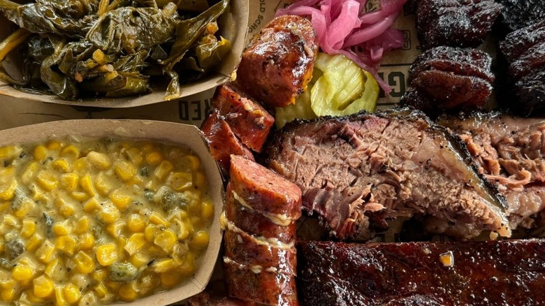 Wright's Barbecue 3 meat plat of moist brisket, ribs, and pork belly burnt ends plus a regular beef sausage. Collared greens and poblano creamed corn.