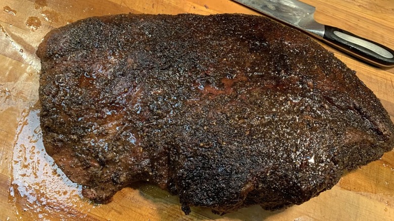 Wayne's Smoke Shack brisket beside cutting knife on a cutting board