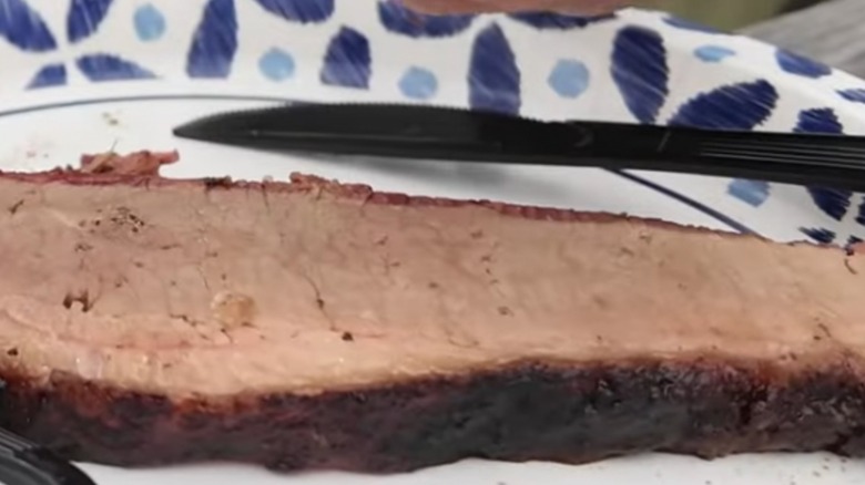Bethany Blues slice of brisket on paper plate beside plastic fork