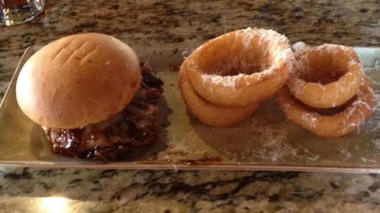 BBQ Brisket sandwich with side of onion rings from Black Iron Grill Rotisserie