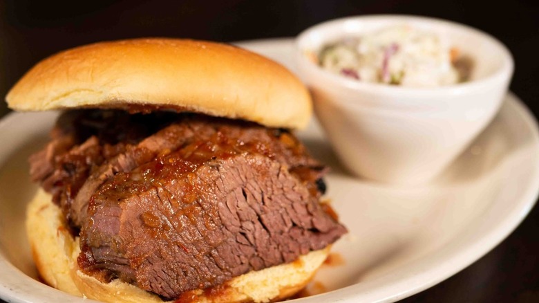 Texas Brisket Sandwich with a side blurred in the background from Spitfire Bar & Grill