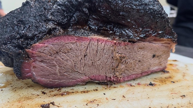 Brisket on wooden cutting board from Smoked On High BBQ