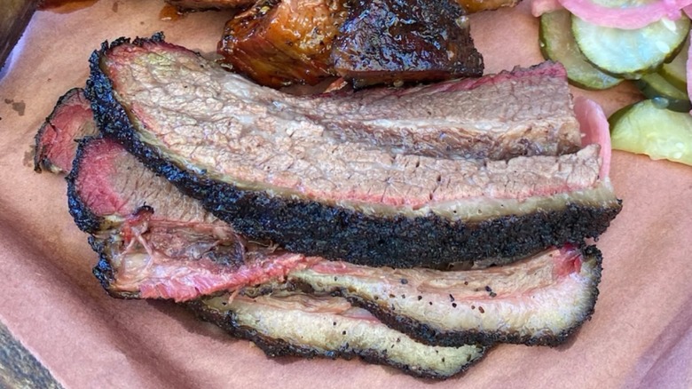 Sliced brisket with pickles on the side from Matt's BBQ