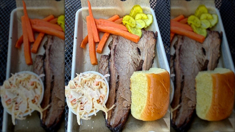 Smoked Brisket with sides of slaw and pickles and carrots and dinner roll from Prohibition Pig Restaurant