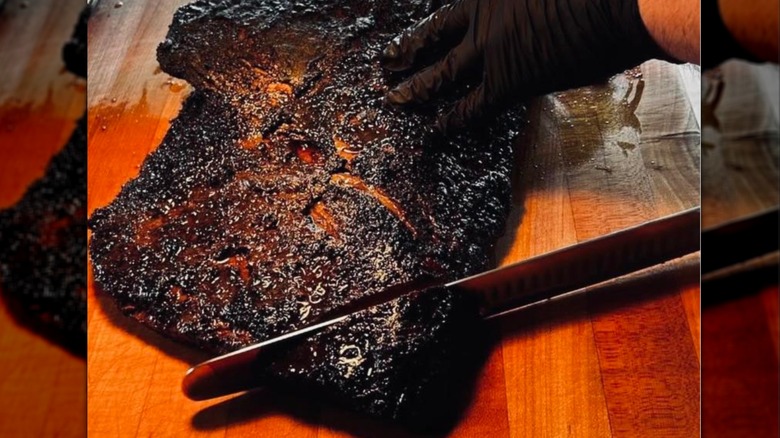 Brisket being sliced by a gloved hand at KRB's Klingers Real Barbeque