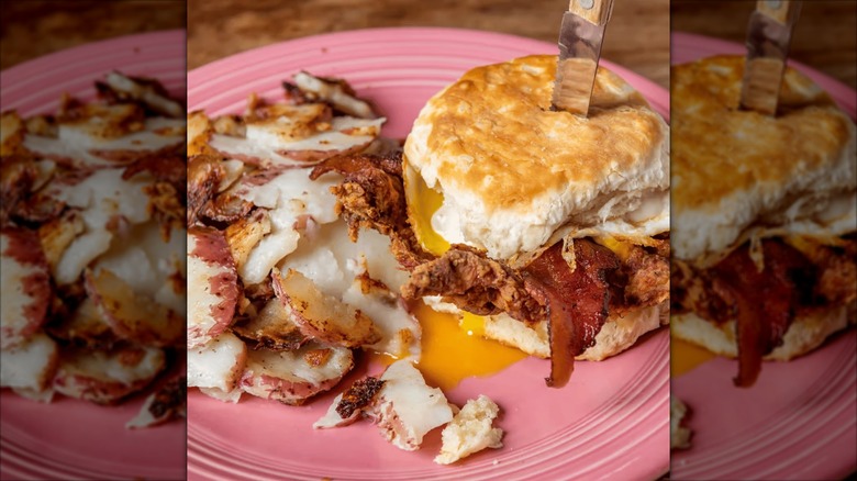 Henhouse Cafe breakfast biscuit with bacon and sides of breakfast potatoes