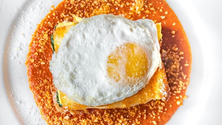 Immigrant Son Caffé Homemade Breakfast Lasagna topped with fried egg
