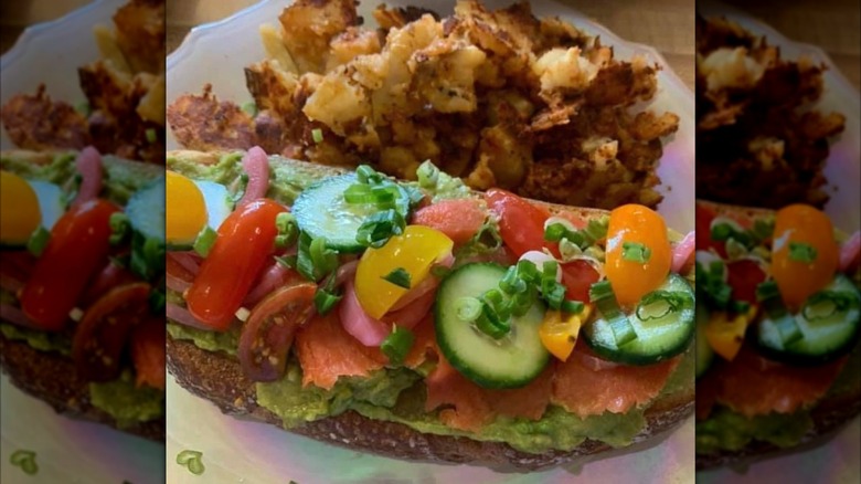 The Corner Restaurant avocado toast with sliced cucumbers, cherry tomatoes, and side of hashbrowns