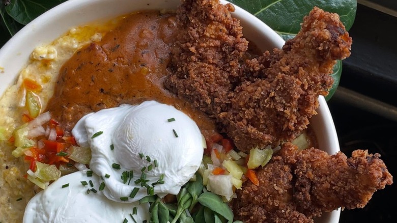 The Dandy Lion Hop-a-long Grits with Fried frog legs, Tasso gravy, local sprouts, poached eggs, and pickled cajun trinity