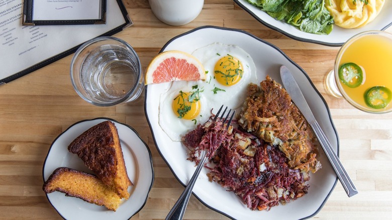 Hot Suppa brunch spread with fried eggs, hashbrowns, slice of grapefruit, and side of cake